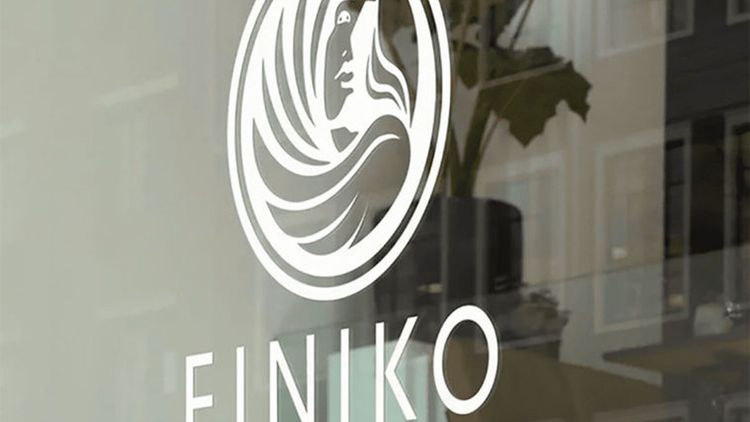 Finiko office sign with the company logo on glass
